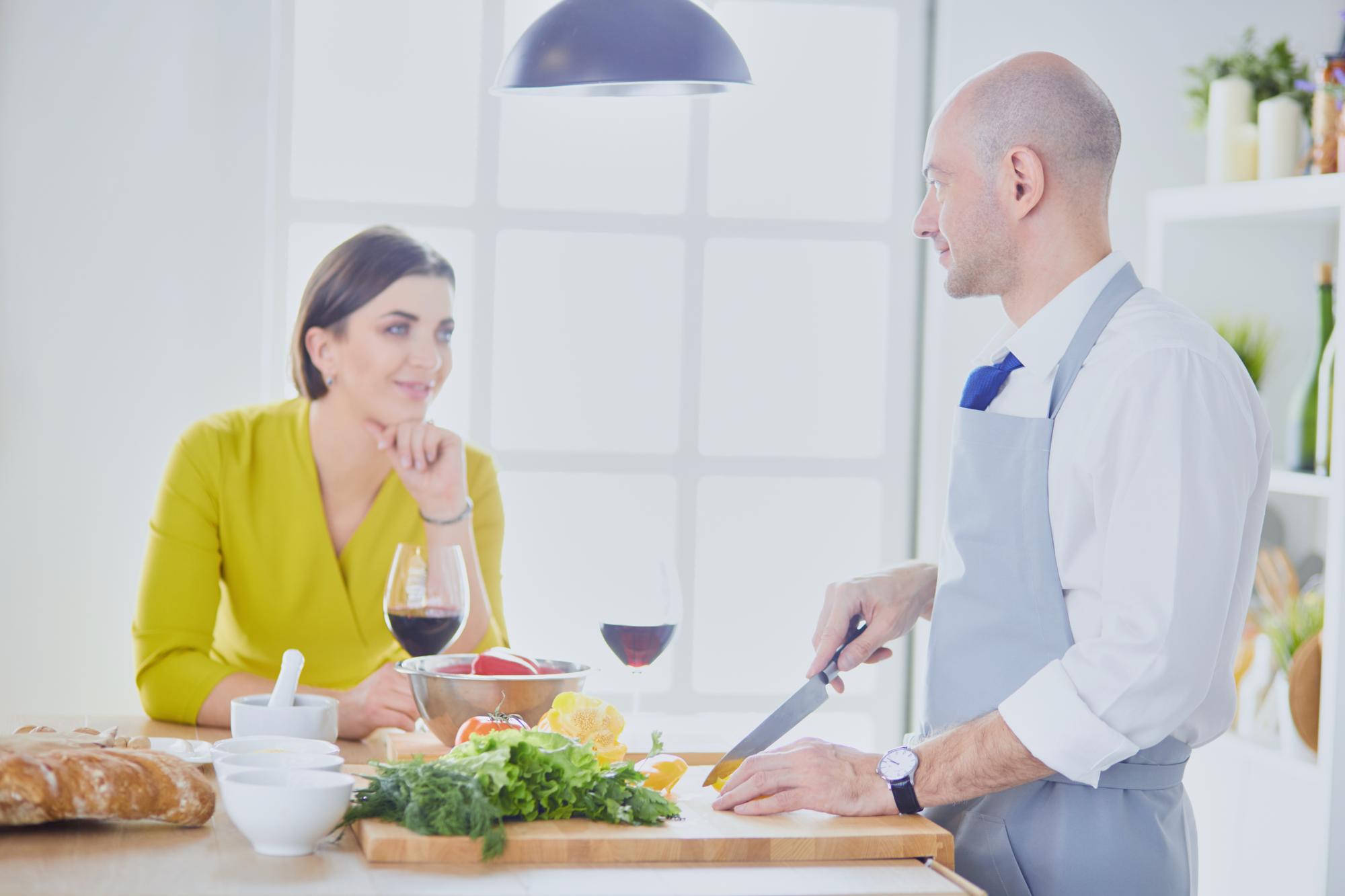Chef speaking with guests across a softly lit table